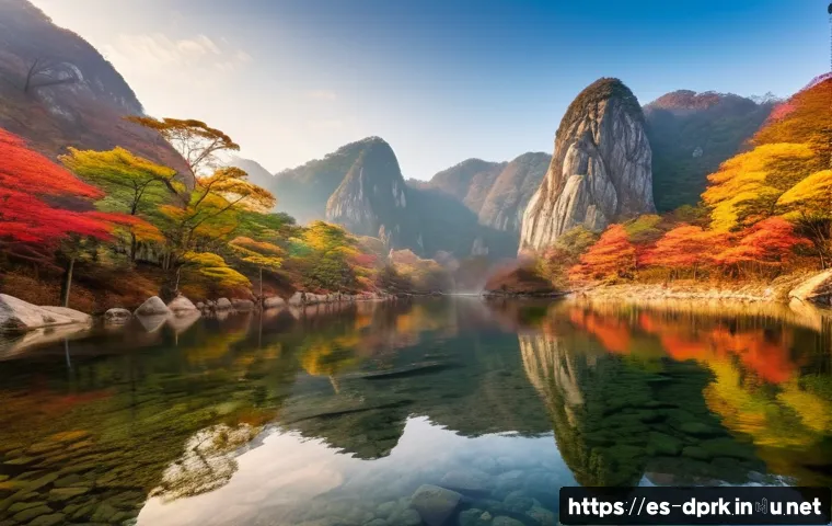 조선민주주의인민공화국 관광지   금강산 등산정보 - A breathtaking panoramic view of the Kumgang Mountain during autumn, featuring rocky peaks partially...